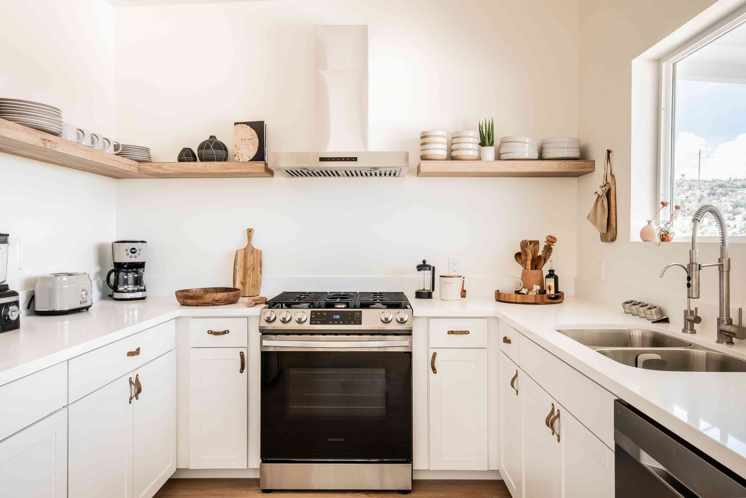 Bright U-shaped kitchen with white IKEA kitchen cabinets for small kitchens and open wood shelves