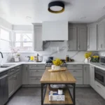 Modern grey Kitchen Cabinets Brampton design with shaker-style cabinets, marble backsplash, and wooden kitchen island in a bright contemporary kitchen.
