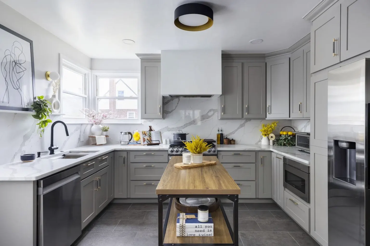 Modern grey Kitchen Cabinets Brampton design with shaker-style cabinets, marble backsplash, and wooden kitchen island in a bright contemporary kitchen.