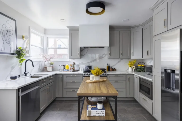 Modern grey Kitchen Cabinets Brampton design with shaker-style cabinets, marble backsplash, and wooden kitchen island in a bright contemporary kitchen.