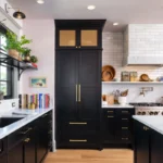 Modern kitchen with black shaker RTA kitchen cabinets, brass hardware, and marble countertops.