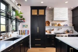 Modern kitchen with black shaker RTA kitchen cabinets, brass hardware, and marble countertops.