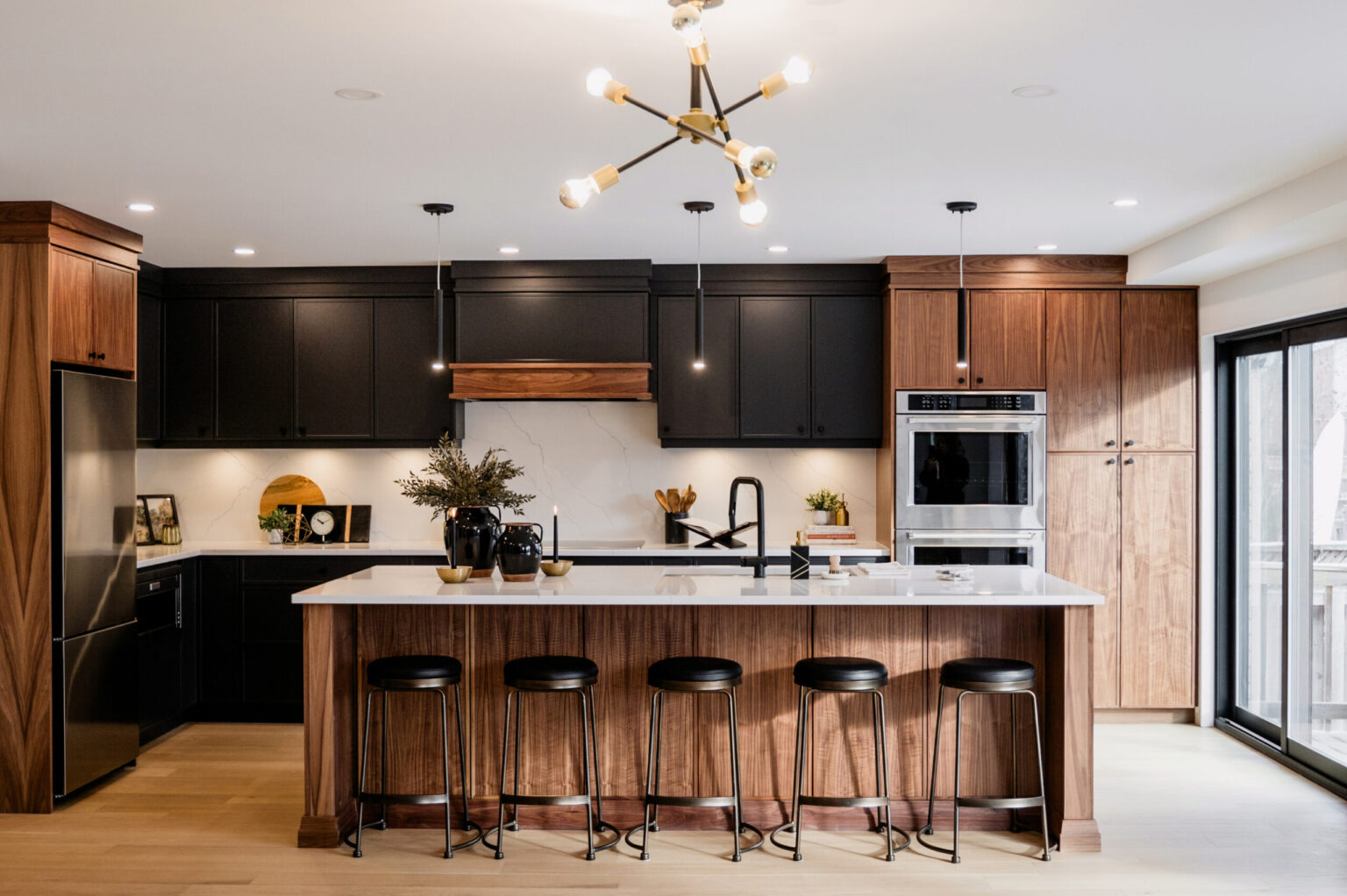 Modern Kitchen Cabinets Hamilton design featuring black and walnut cabinetry, a large island with seating, and minimalist pendant lighting in a contemporary open-concept kitchen.