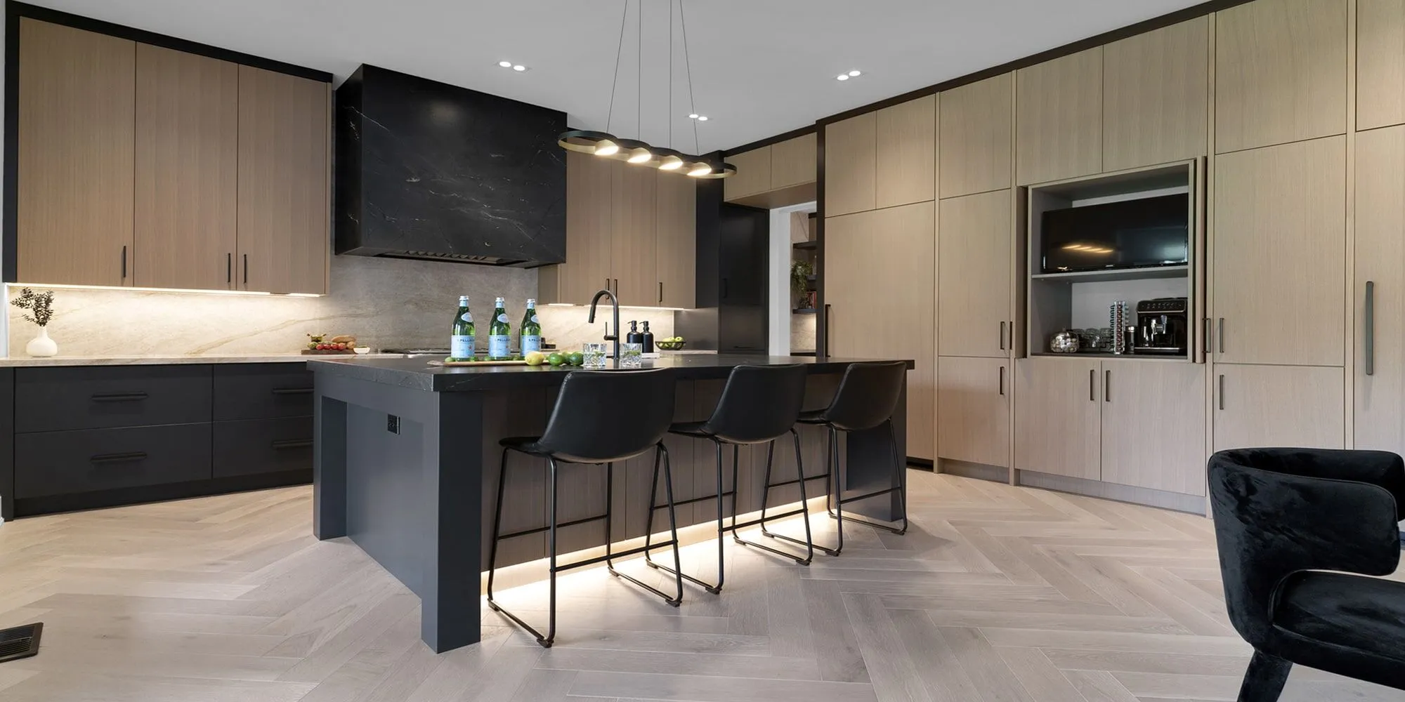 Modern Kitchen Cabinets Vaughan with natural wood finishes, black island, and contemporary lighting in a luxury open-concept kitchen.
