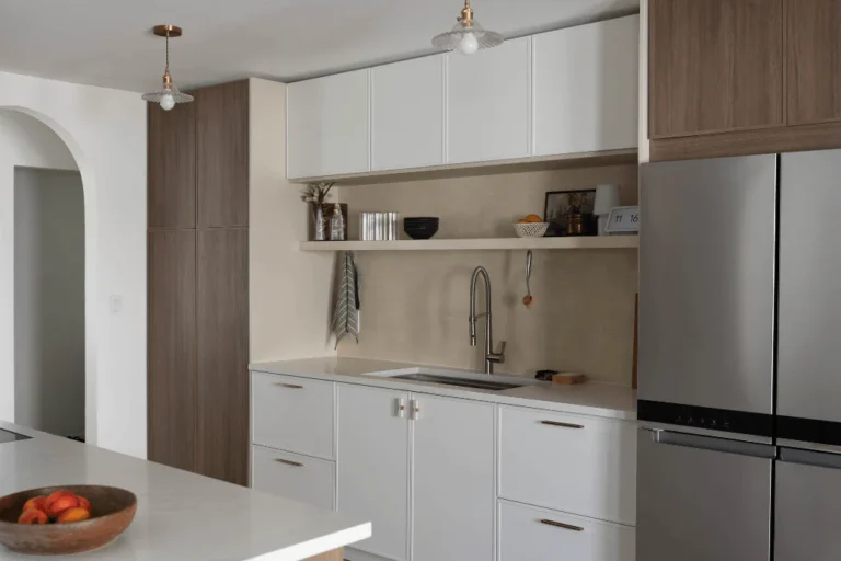 Kitchen cabinets Mississauga in a modern minimalist kitchen with white flat-panel cabinets and wood pantry units