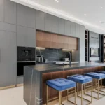 Modern Kitchen Cabinets Richmond Hill design with matte gray cabinetry, wood accents, and a large marble waterfall island