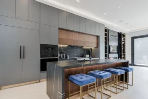 Modern Kitchen Cabinets Richmond Hill design with matte gray cabinetry, wood accents, and a large marble waterfall island