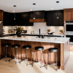 Kitchen Cabinets Hamilton featuring warm wood shaker cabinets, a marble waterfall island, pendant lighting, and a bright modern open-concept kitchen design.