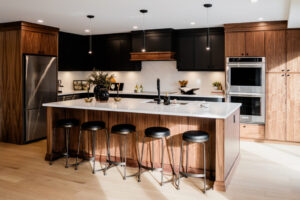 Kitchen Cabinets Hamilton featuring warm wood shaker cabinets, a marble waterfall island, pendant lighting, and a bright modern open-concept kitchen design.