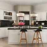 Modern white Kitchen Cabinets Richmond Hill with black countertops, glass-front upper cabinets, a central island, pendant lights, and wooden bar stools in a bright luxury kitchen.