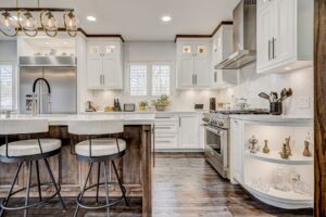 Modern white Kitchen Cabinets Etobicoke with shaker-style doors, wood island, stainless steel appliances, and open corner shelving