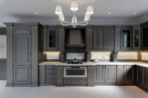 Luxury Kitchen Cabinets Oakville design with dark gray cabinetry, ornate trim, marble countertops, and warm under-cabinet lighting.