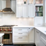 IKEA kitchen cabinets in a modern white kitchen with quartz countertops