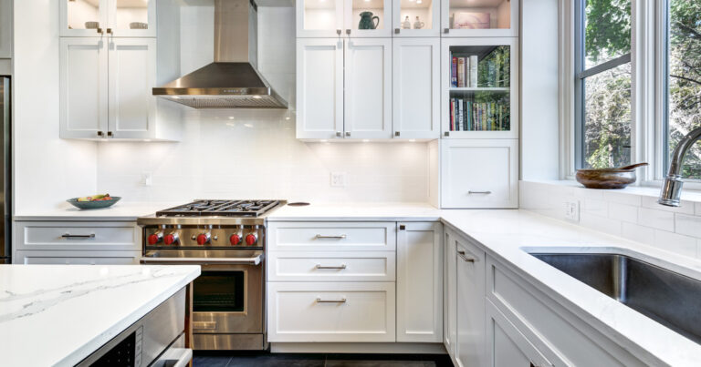 IKEA kitchen cabinets in a modern white kitchen with quartz countertops