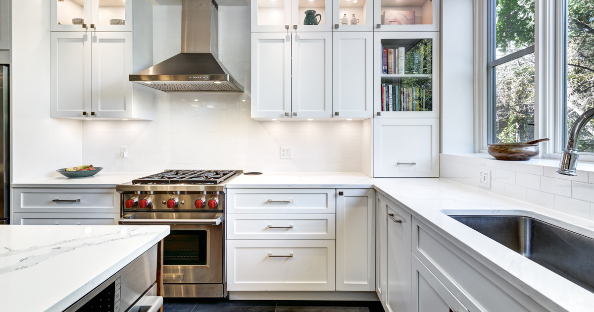 IKEA kitchen cabinets in a modern white kitchen with quartz countertops
