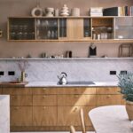 Modern RTA kitchen cabinets with natural wood finish, glass upper cabinets, and marble backsplash