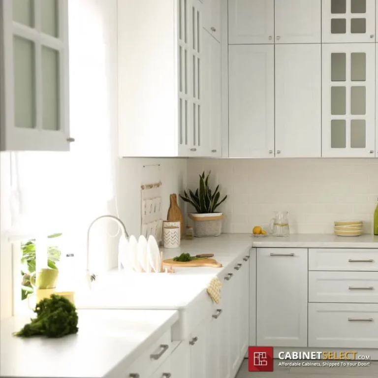 Glossy white cabinet style in a bright modern kitchen with white shaker cabinets and glass doors