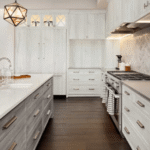 Premium kitchen cabinets Mississauga and Toronto – dark navy shaker cabinets with brass hardware and white subway tile backsplash
