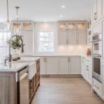 modern white kitchen cabinet with gold handles and farmhouse sink design