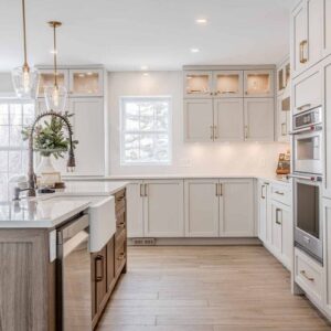 modern white kitchen cabinet with gold handles and farmhouse sink design