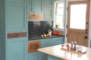 RTA kitchen cabinets in a modern kitchen with blue shaker cabinet doors and wood accents