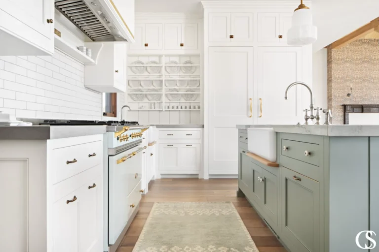 Premium kitchen cabinets in Mississauga and Toronto with white shaker cabinetry, brass hardware, and sage green kitchen island