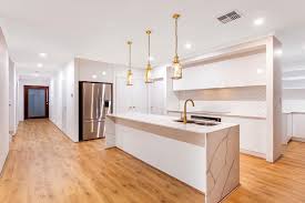 Modern kitchen cabinet design with natural wood lower cabinets, black upper cabinets, and a sleek island