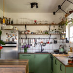 RTA kitchen cabinets in a small modern kitchen with green base cabinets and open shelving