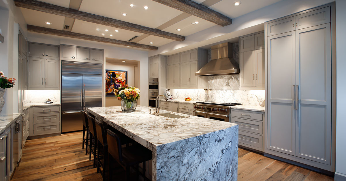 RTA kitchen cabinets Ontario in a modern grey shaker kitchen with waterfall stone island