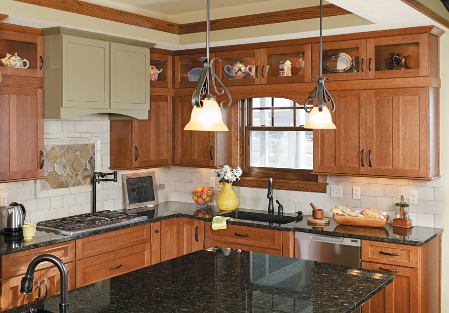 modern wooden kitchen cabinet design with glass upper cabinets and black countertop