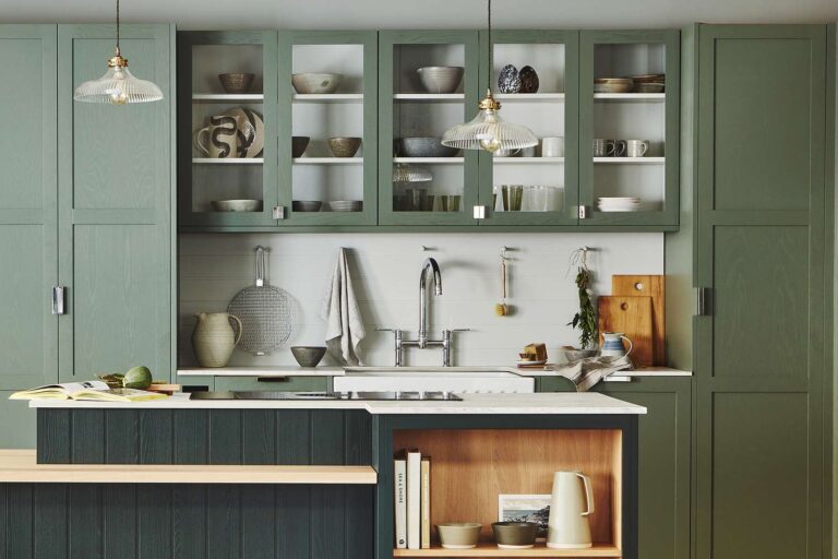 Kitchen Cabinet in sage green with glass upper cabinets and kitchen island