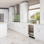 Bright white kitchen with shaker cabinets, marble floor, green tile backsplash and kitchen island