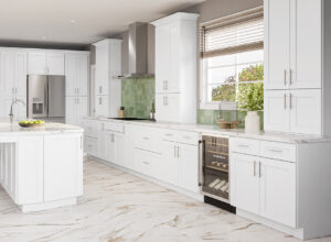 Bright white kitchen with shaker cabinets, marble floor, green tile backsplash and kitchen island