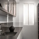 Modern kitchen with white slab kitchen cabinet doors and black countertop