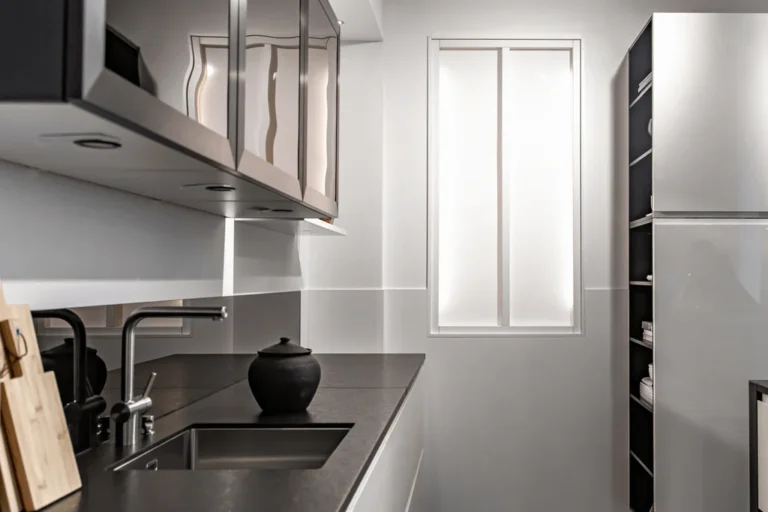 Modern kitchen with white slab kitchen cabinet doors and black countertop