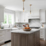Modern kitchen by kitchen suppliers with white cabinets and wood island