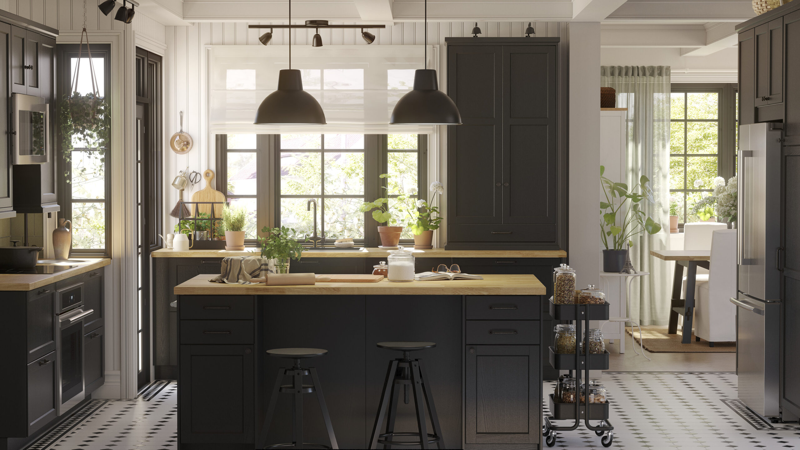 Black IKEA kitchen cabinets styled to look custom with a wood island countertop, full-height cabinetry, pendant lighting, and a bright, upscale layout.